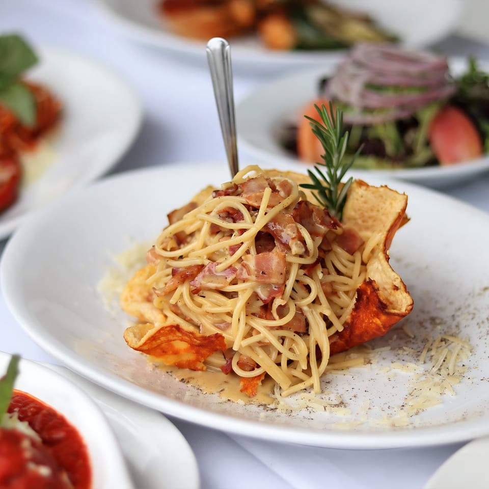 Spaghetti carbonara with bacon and rosemary, served in a crispy cheese bowl at Mickey's Downtown Bistro.